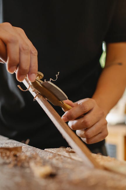 Close-up of hands blending materials on a workshop table